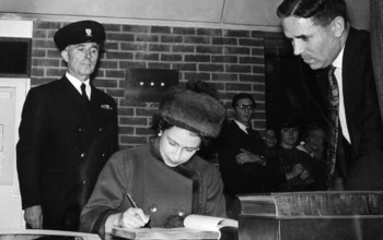 The Queen signing a document at the ɫ